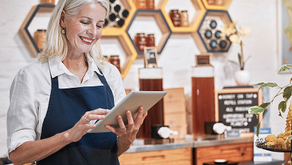 elder woman on tablet at business
