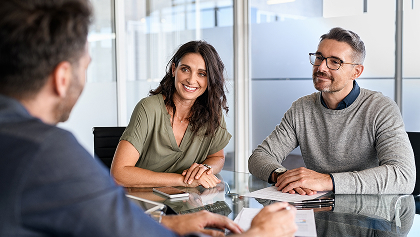 couple looking over paperwork with lawyer