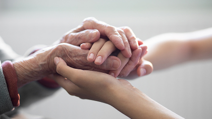 grandparent holding child hands