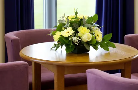 Reception area with floral display and seating in a Funeral directors