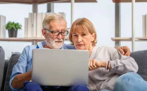Mature woman and senior man using laptop in living room, Portrait of Worried senior couple checking their bills and work on netbook read document information at home  Thank you This photo has been successfully downloaded. (Look for it in your Downloads fol
