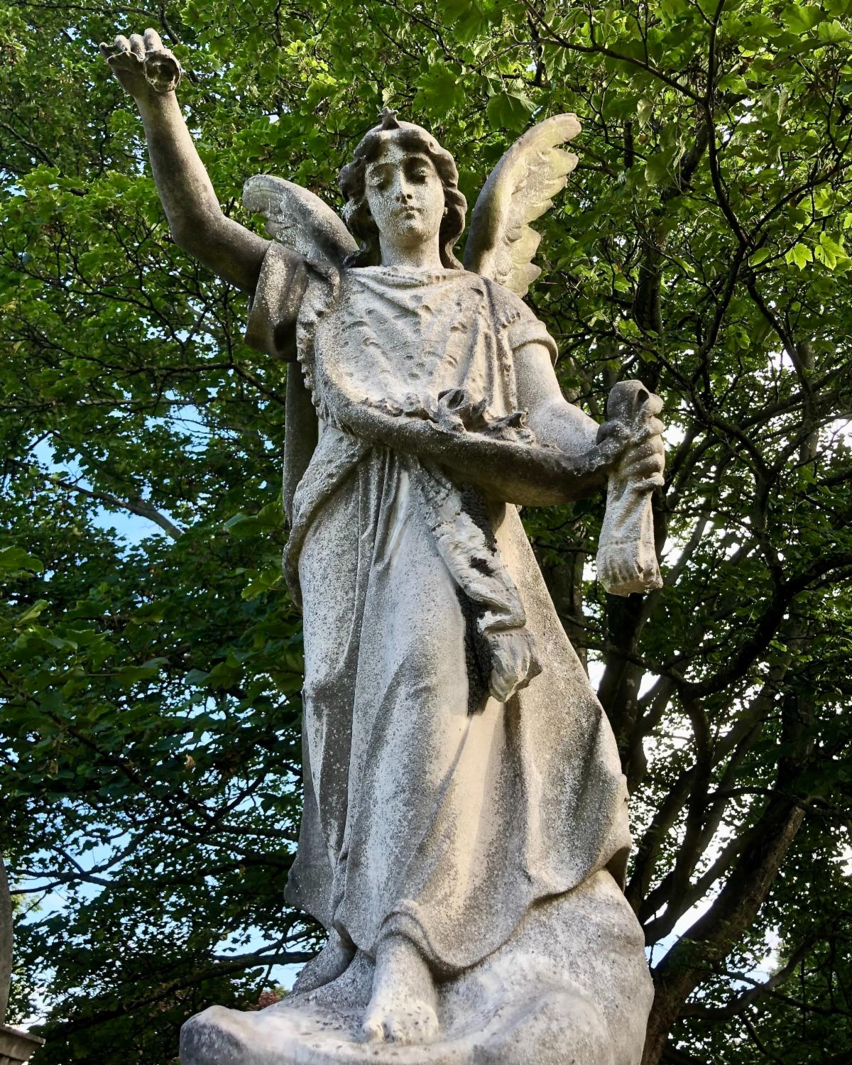 A statue of an angel holding a bird